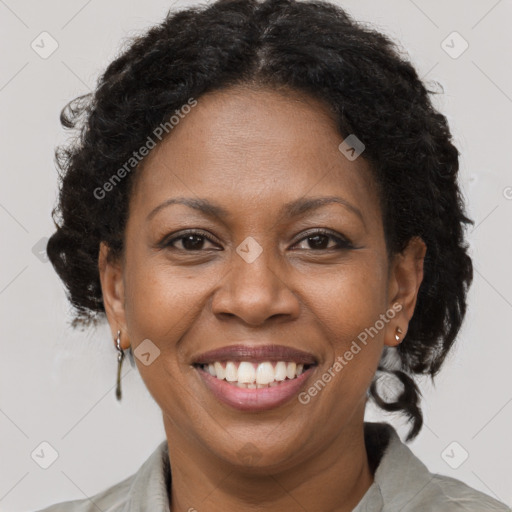 Joyful black adult female with medium  brown hair and brown eyes