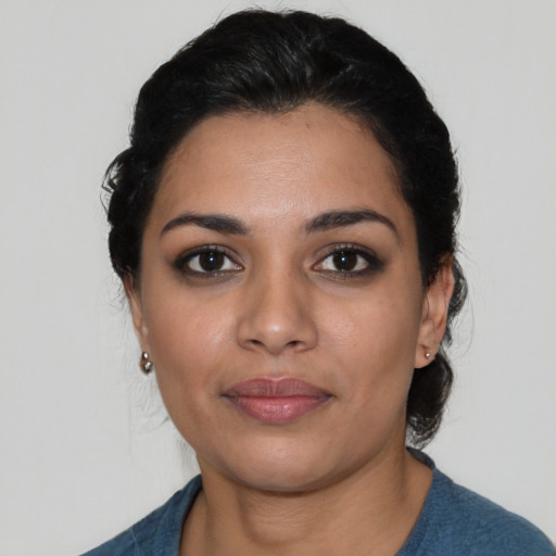 Joyful latino young-adult female with medium  black hair and brown eyes