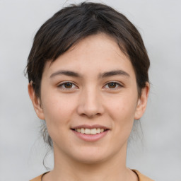 Joyful white young-adult female with medium  brown hair and brown eyes