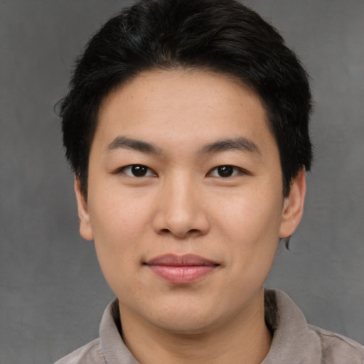 Joyful asian young-adult female with short  brown hair and brown eyes
