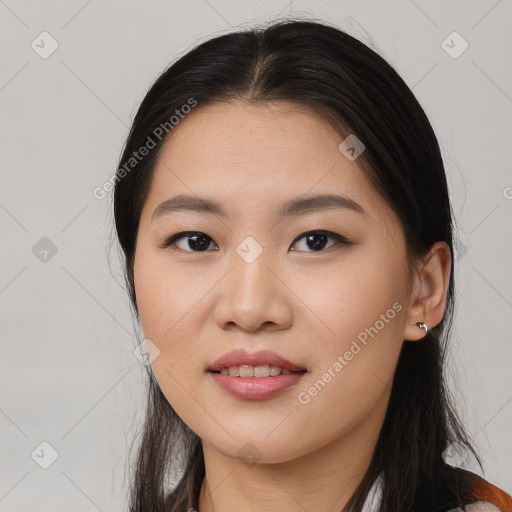 Joyful asian young-adult female with long  brown hair and brown eyes