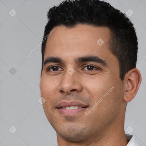 Joyful white young-adult male with short  black hair and brown eyes