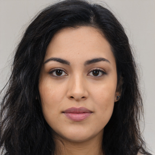 Joyful latino young-adult female with long  brown hair and brown eyes
