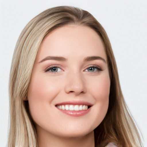 Joyful white young-adult female with long  brown hair and blue eyes