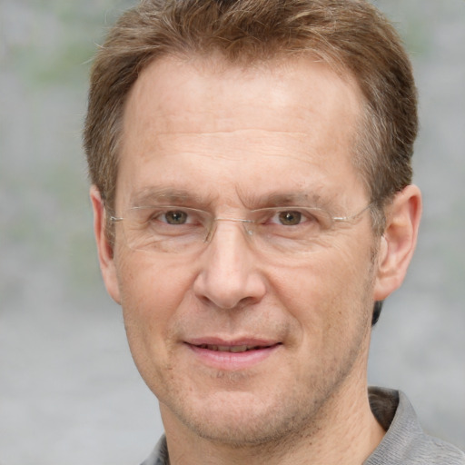 Joyful white middle-aged male with short  brown hair and grey eyes