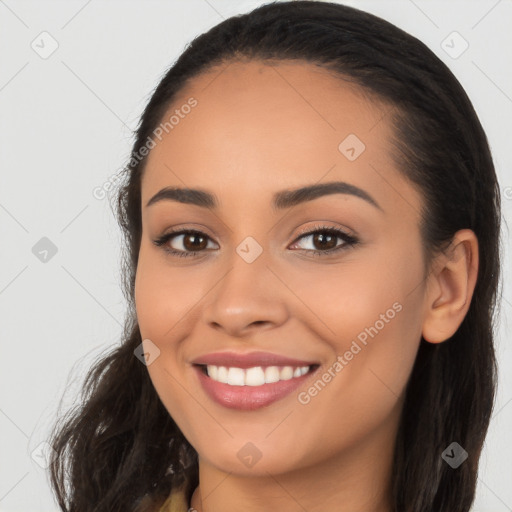 Joyful latino young-adult female with long  brown hair and brown eyes