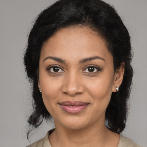 Joyful black young-adult female with medium  black hair and brown eyes
