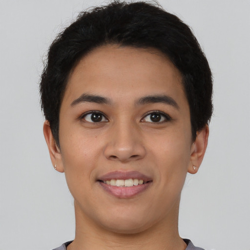 Joyful latino young-adult female with short  black hair and brown eyes