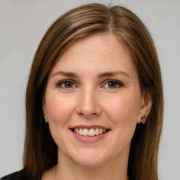 Joyful white young-adult female with medium  brown hair and green eyes