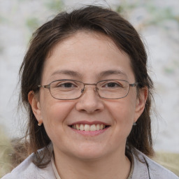 Joyful white adult female with medium  brown hair and brown eyes