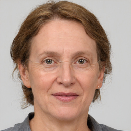 Joyful white middle-aged female with medium  brown hair and grey eyes