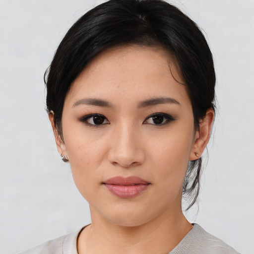 Joyful asian young-adult female with medium  black hair and brown eyes