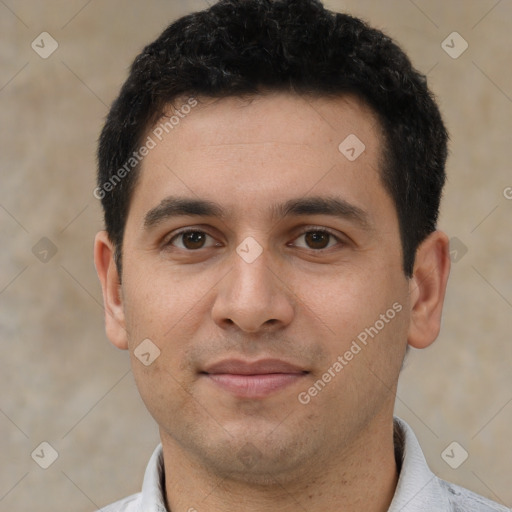 Joyful white young-adult male with short  black hair and brown eyes