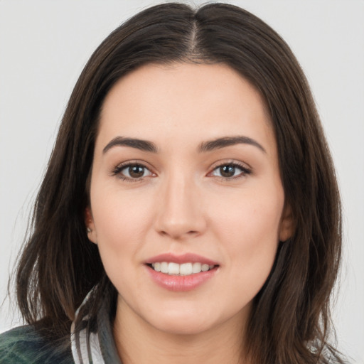 Joyful white young-adult female with long  brown hair and brown eyes