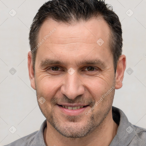 Joyful white adult male with short  brown hair and brown eyes