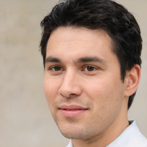 Joyful white young-adult male with short  black hair and brown eyes