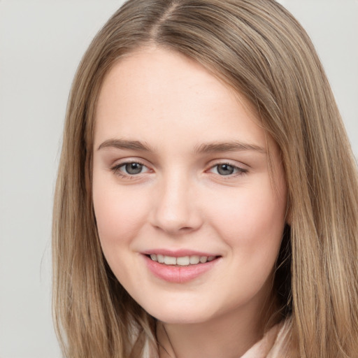 Joyful white young-adult female with long  brown hair and grey eyes