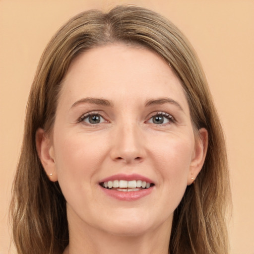 Joyful white adult female with long  brown hair and grey eyes