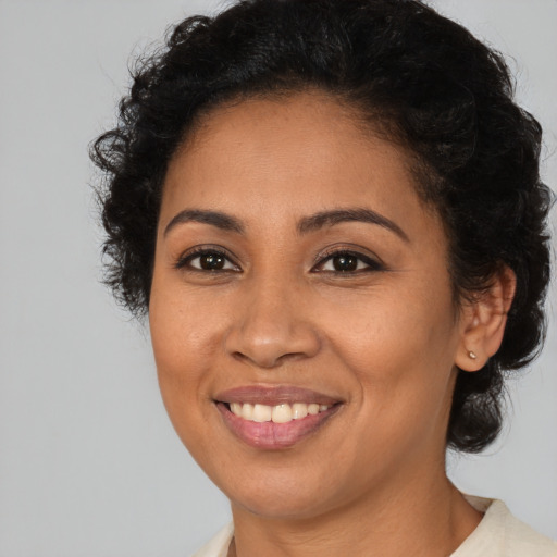 Joyful latino young-adult female with short  brown hair and brown eyes