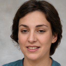 Joyful white young-adult female with medium  brown hair and green eyes