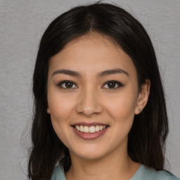 Joyful asian young-adult female with long  brown hair and brown eyes