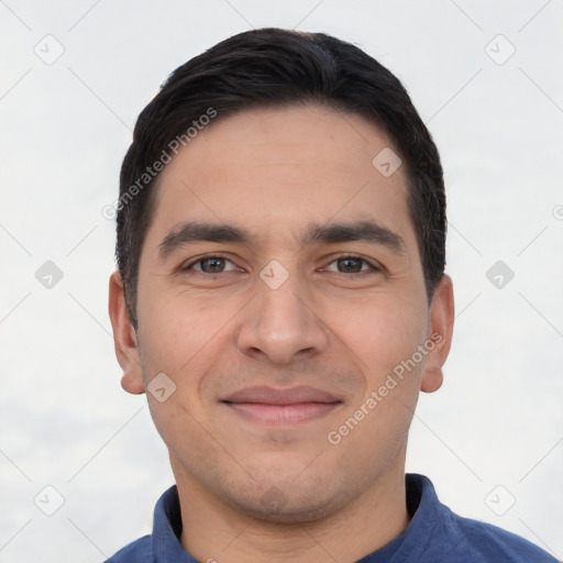 Joyful white young-adult male with short  black hair and brown eyes