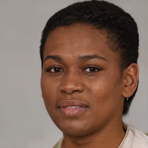 Joyful black young-adult female with short  brown hair and brown eyes