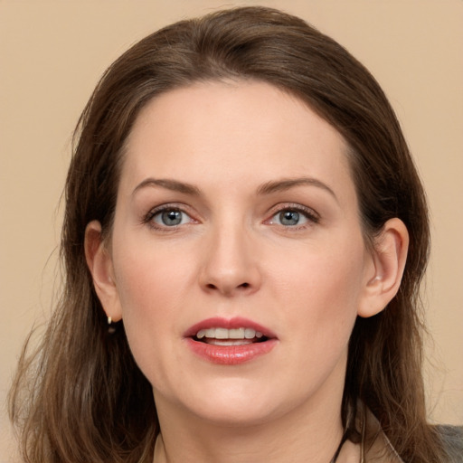 Joyful white young-adult female with long  brown hair and grey eyes