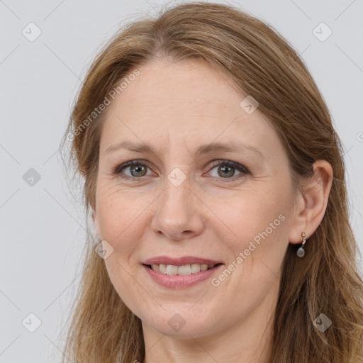 Joyful white adult female with long  brown hair and grey eyes