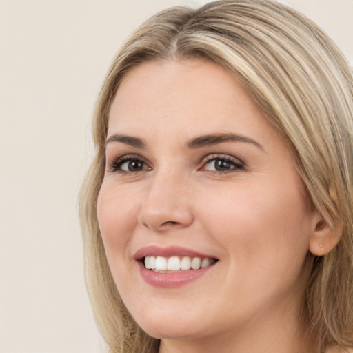 Joyful white young-adult female with long  brown hair and brown eyes