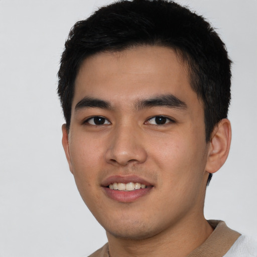 Joyful asian young-adult male with short  brown hair and brown eyes