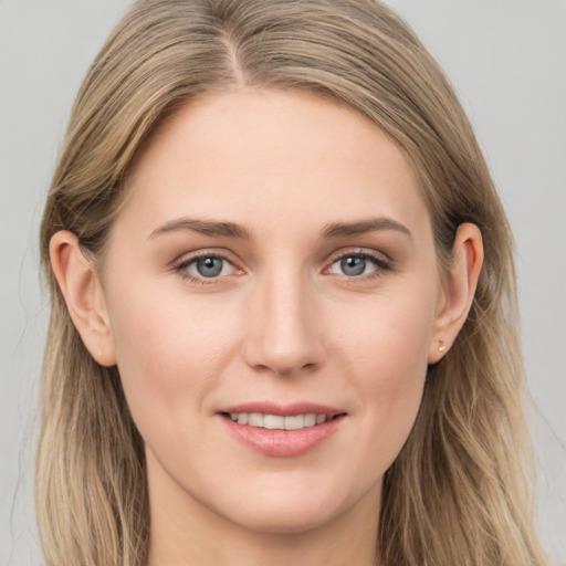 Joyful white young-adult female with long  brown hair and grey eyes