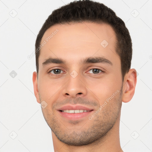 Joyful white young-adult male with short  brown hair and brown eyes