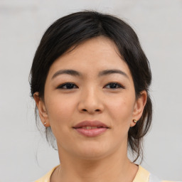 Joyful asian young-adult female with medium  brown hair and brown eyes