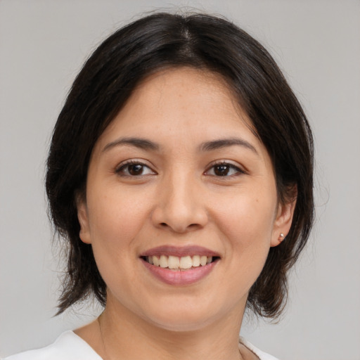 Joyful white young-adult female with medium  brown hair and brown eyes