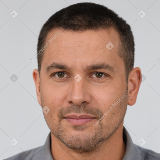 Joyful white adult male with short  brown hair and brown eyes