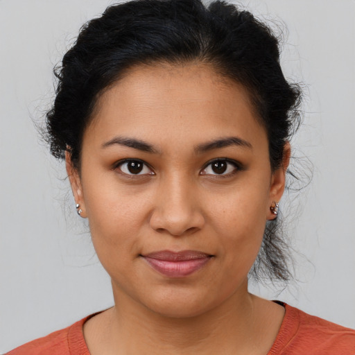 Joyful latino young-adult female with medium  brown hair and brown eyes