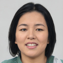 Joyful asian young-adult female with medium  black hair and brown eyes