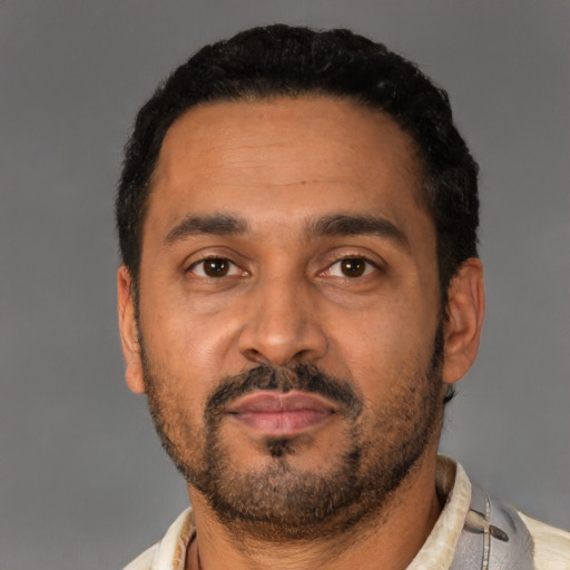 Neutral latino adult male with short  black hair and brown eyes