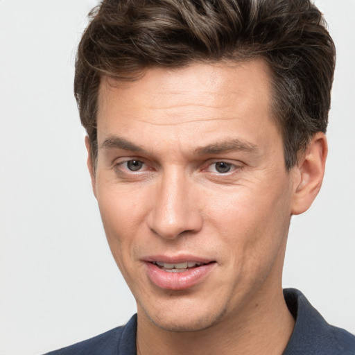 Joyful white adult male with short  brown hair and brown eyes