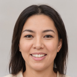 Joyful latino young-adult female with medium  brown hair and brown eyes