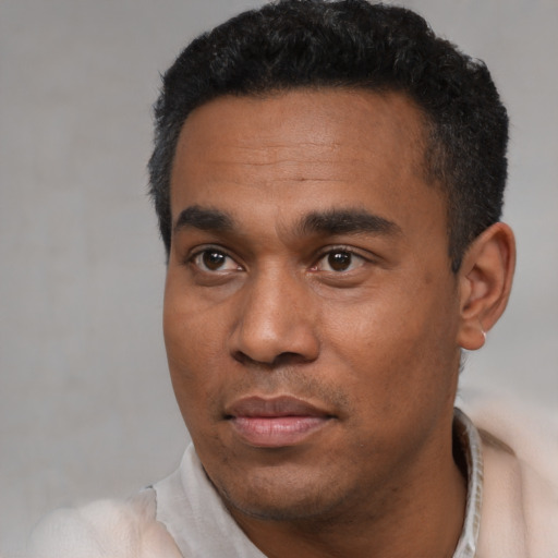 Neutral latino young-adult male with short  black hair and brown eyes
