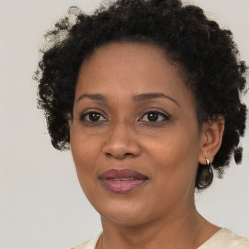 Joyful black adult female with short  brown hair and brown eyes