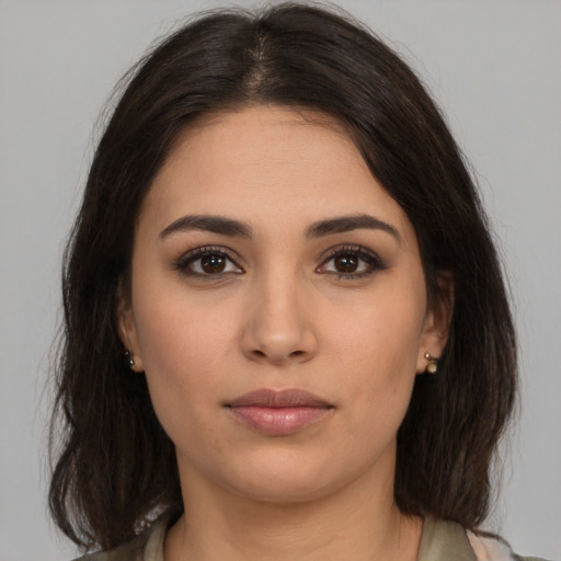 Neutral latino young-adult female with medium  brown hair and brown eyes