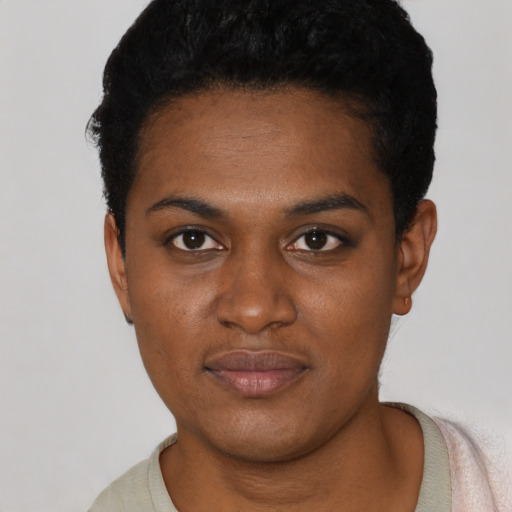 Joyful black young-adult female with short  black hair and brown eyes
