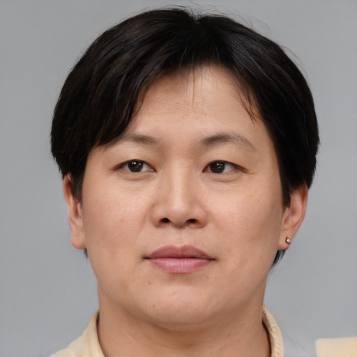 Neutral asian adult female with short  brown hair and brown eyes