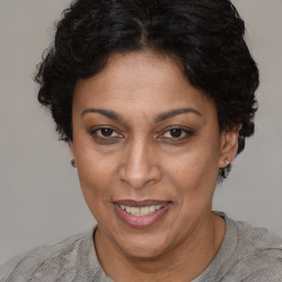 Joyful latino adult female with short  brown hair and brown eyes