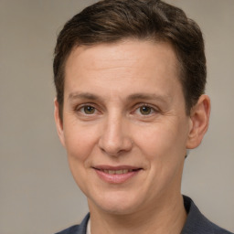 Joyful white adult male with short  brown hair and grey eyes