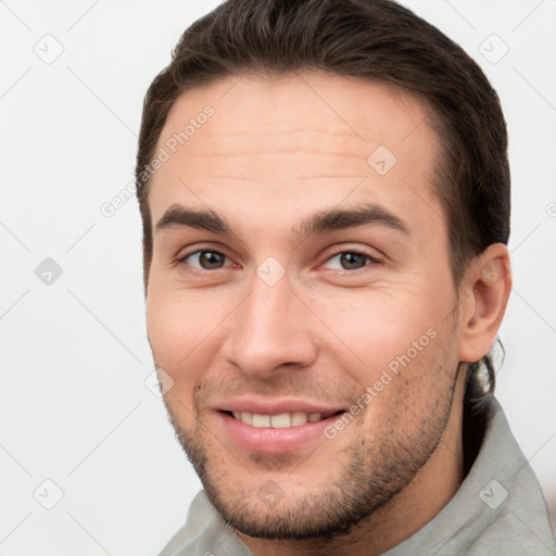 Joyful white young-adult male with short  brown hair and brown eyes