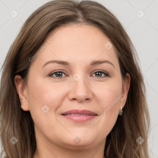 Joyful white adult female with long  brown hair and grey eyes